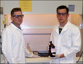 Michael Garrison and Dr. John D. Stenger-Smith examine a bottle of Diiobutylaluminum hydride before beginning a reaction. Photo by L. Stenger-Smith