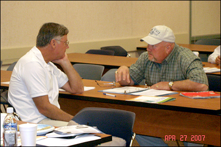 Larry Board (right) discusses articulation with a faculty member