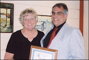 Dr. Mary Retterer (left) congratulates Robert Villicana (right)