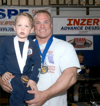 California's strongest man - Cerro Coso Community College, Eastern Sierra College Center, Mammoth Campus student, John Johnson pictured with his four year old son. 