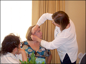 Linda Lyman (Acupuncturist) Ridgecrest Acupuncturist Center- Linda is applying Avuncular Acupressure Ear Seeds to student Suzanne Masons ears to relieve stress.  She applied these seeds to all of the attendees.